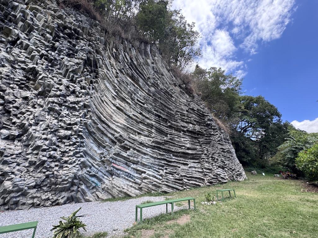 grey rock and green benches seen while E-biking in Panama