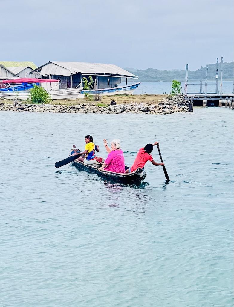 three people in a dugcout canoe on a Cultural Tour of the San Blas Islands
