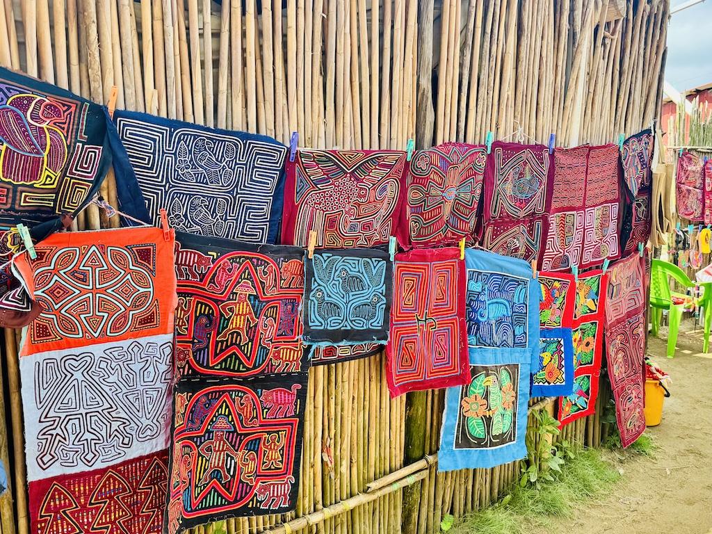colorful textiles hanging on a house on a Cultural Tour of the San Blas Islands