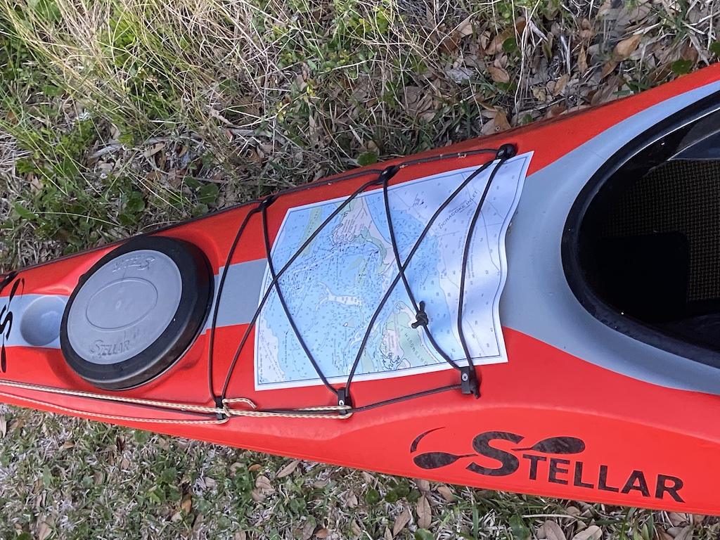 red kayak with chart on deck