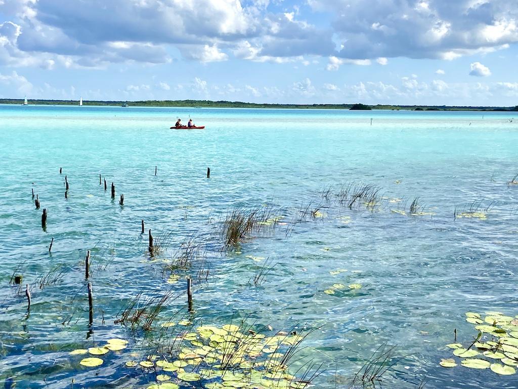 blue water and 2 people in a kayak on an International sea kayaking trip