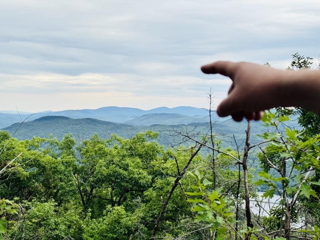 pointing to distant mountains-outdoor adventures in Bethel
