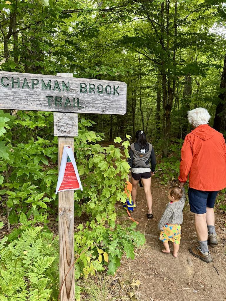 2 women and a baby hiking near trail sign-outdoor adventures in Bethel
