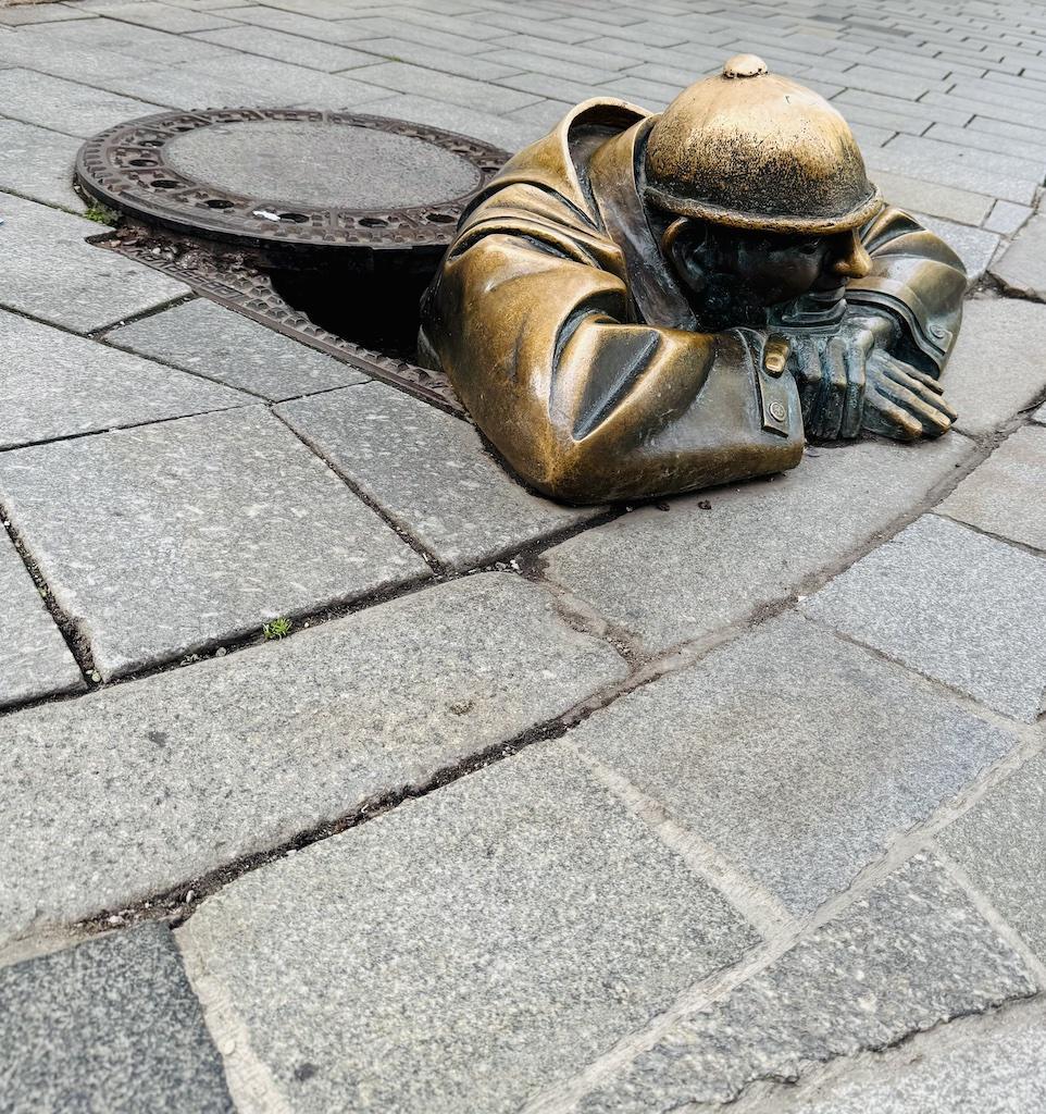 Bronze statue of man with helment seen while biking along the Danube River