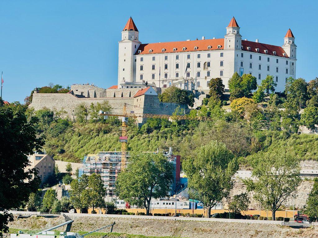white castle with orange roof seen while biking along the Danube River